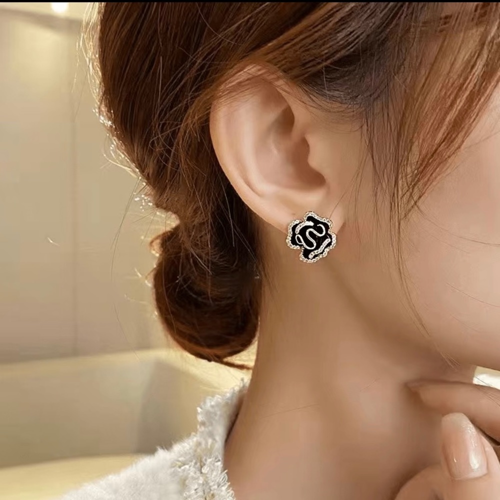 Black enameled camellia stud earrings with rhinestones